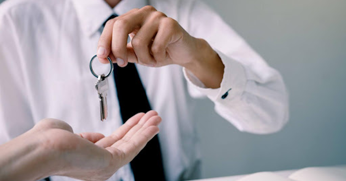 Manager handing company keys to employee
